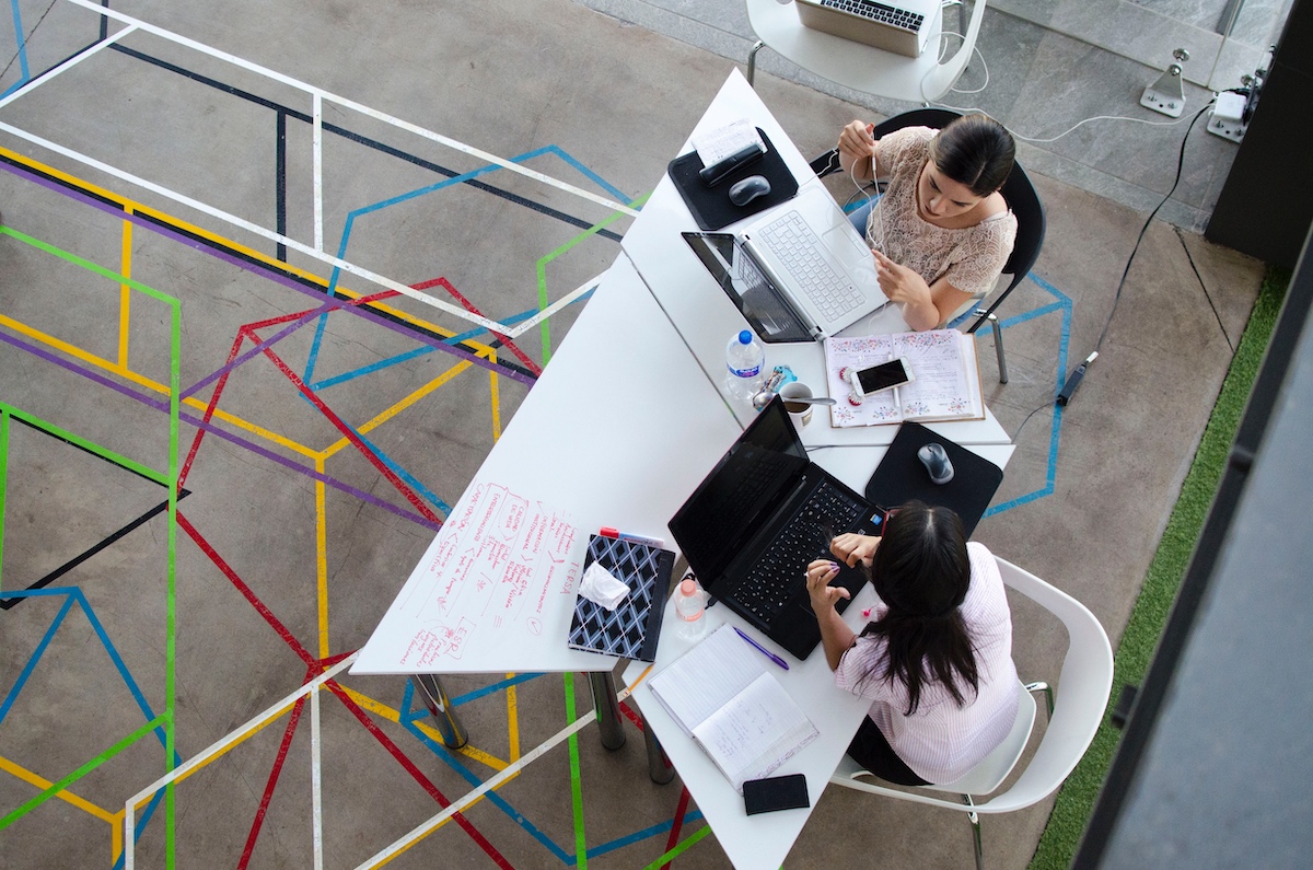 team-dynamics-stock-photo-two-women-working-at-laptops